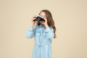 Cute little girl holding a camera