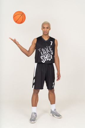 Front view of a young male basketball player throwing a ball