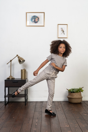 Good looking girl kid posing on the apartment background