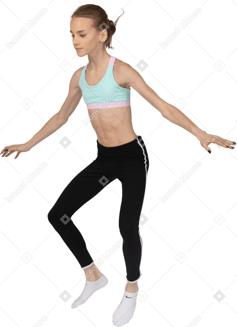 Three-quarter view of a teen girl in sportswear jumping