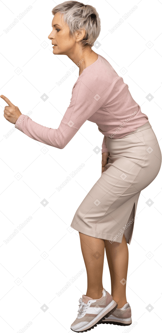 Side view of a woman in casual clothes showing a warning gesture