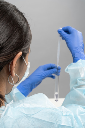 Back view of medical worker with tubes