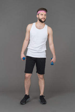 Sporty man holding light dumbbells