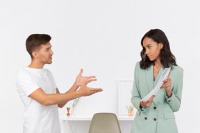 Female boss and male employee figuring out work stuff