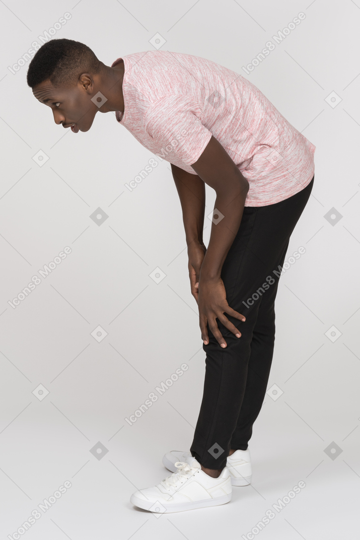Man bending over and looking down