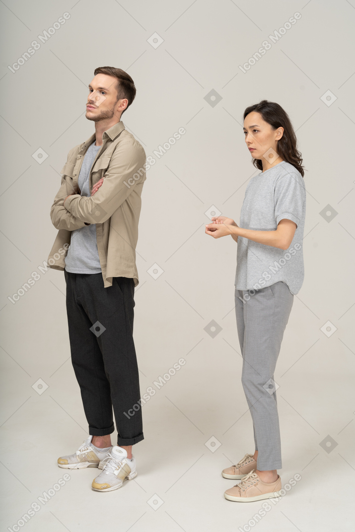 Three-quarter view  of young couple being annoyed