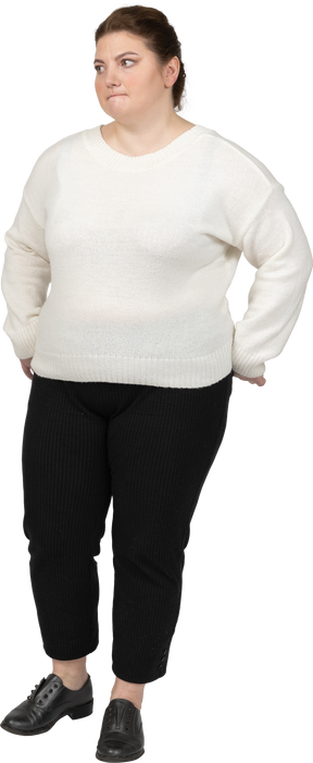 Plus size woman in casual clothes biting her lip