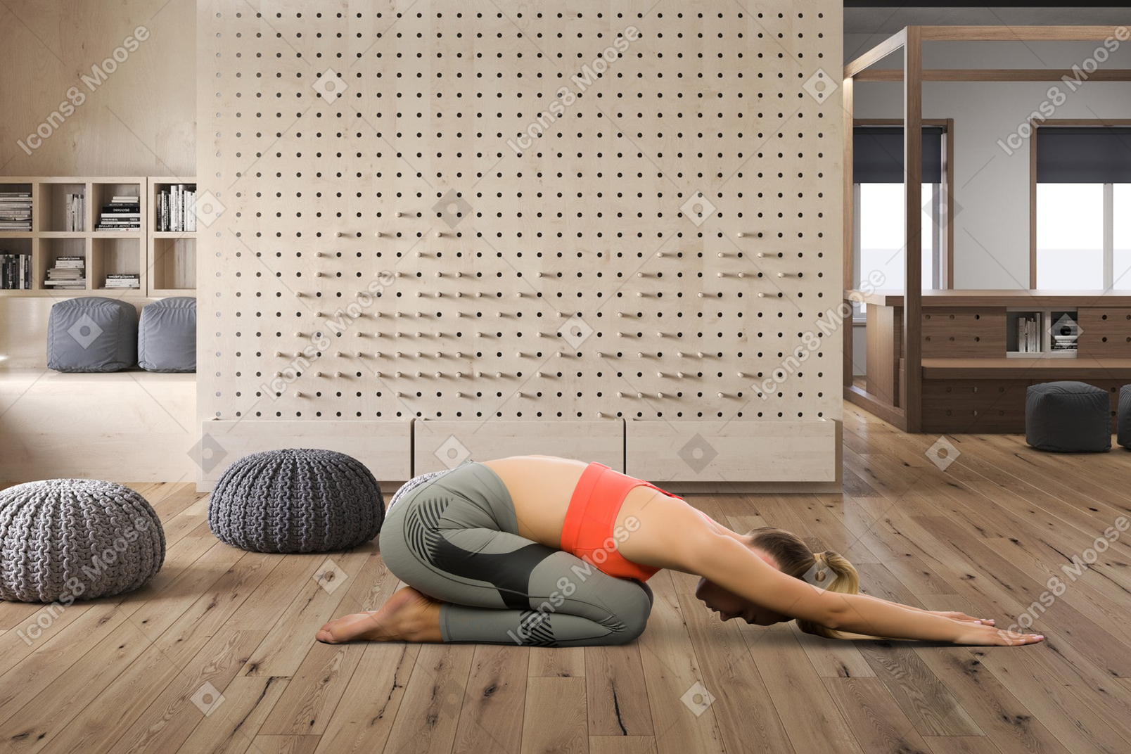 A woman in a yoga position on a wooden floor