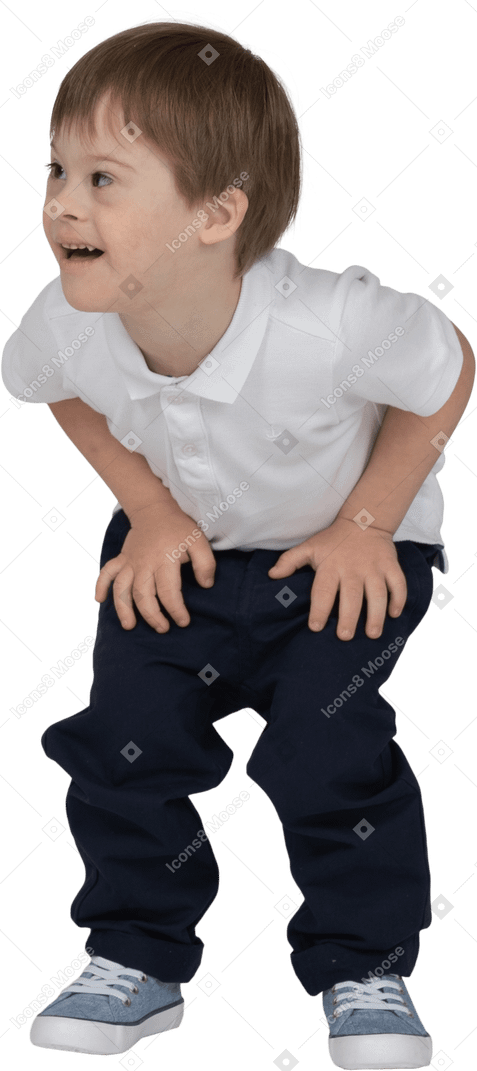 Front view of a boy crouching down and resting his hands on his knees