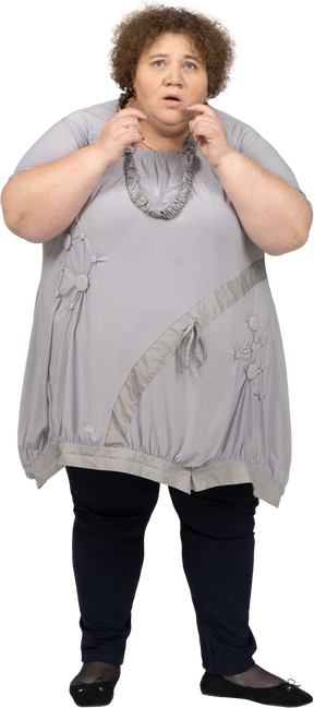 Anxious woman standing with hands near her face