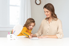 A mother and daughter drawing together