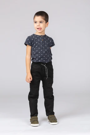 Front view of a cute boy looking at camera and showing tongue