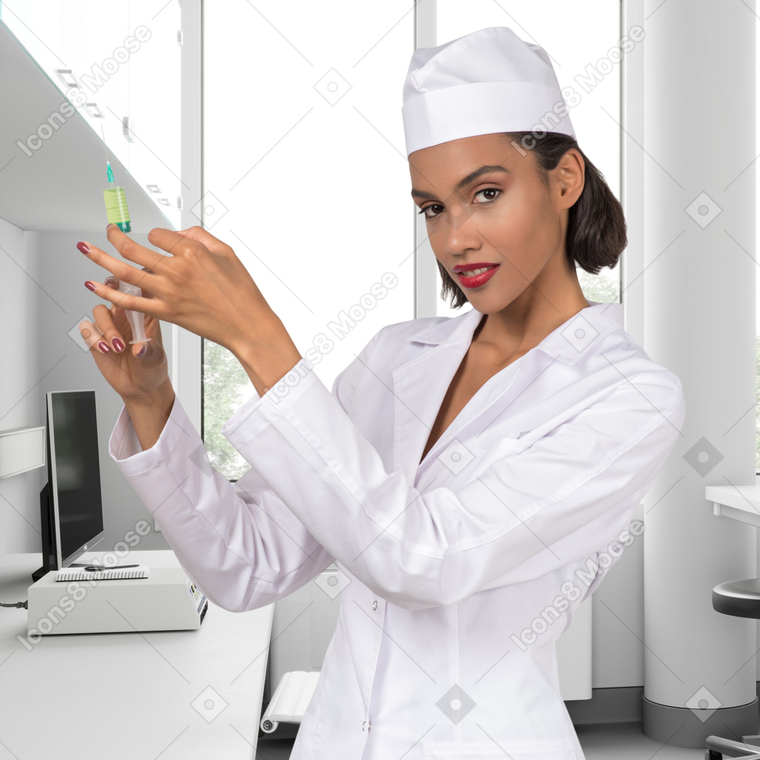 A female nurse is holding a syringe