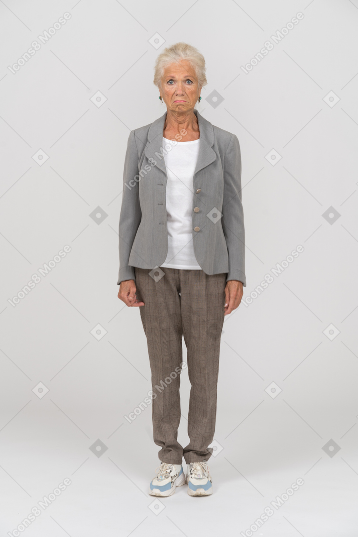Front view of an old woman in grey jacket looking at camera