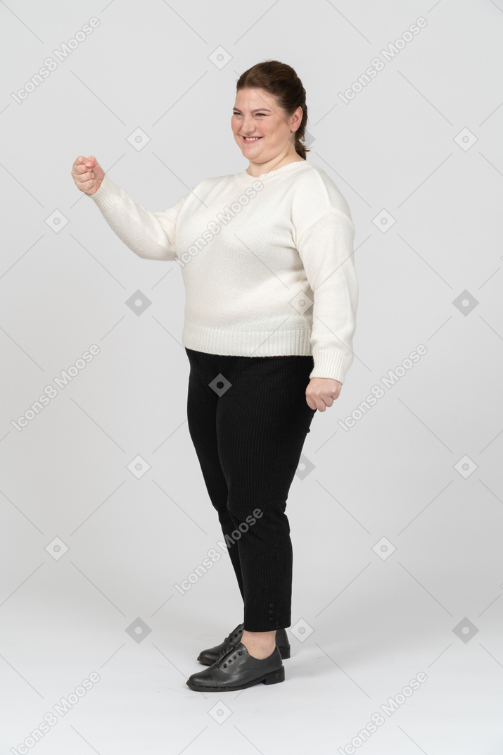 Plus size woman in white shirt posing