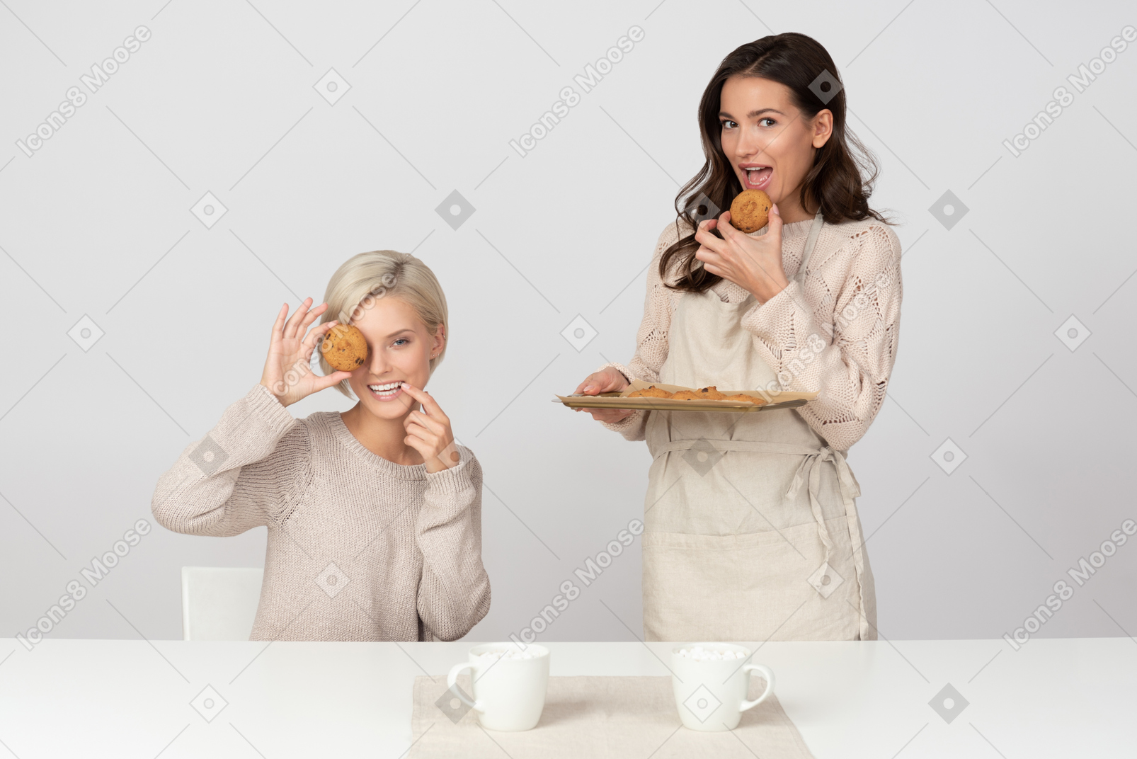 Young women fooling around with cookies