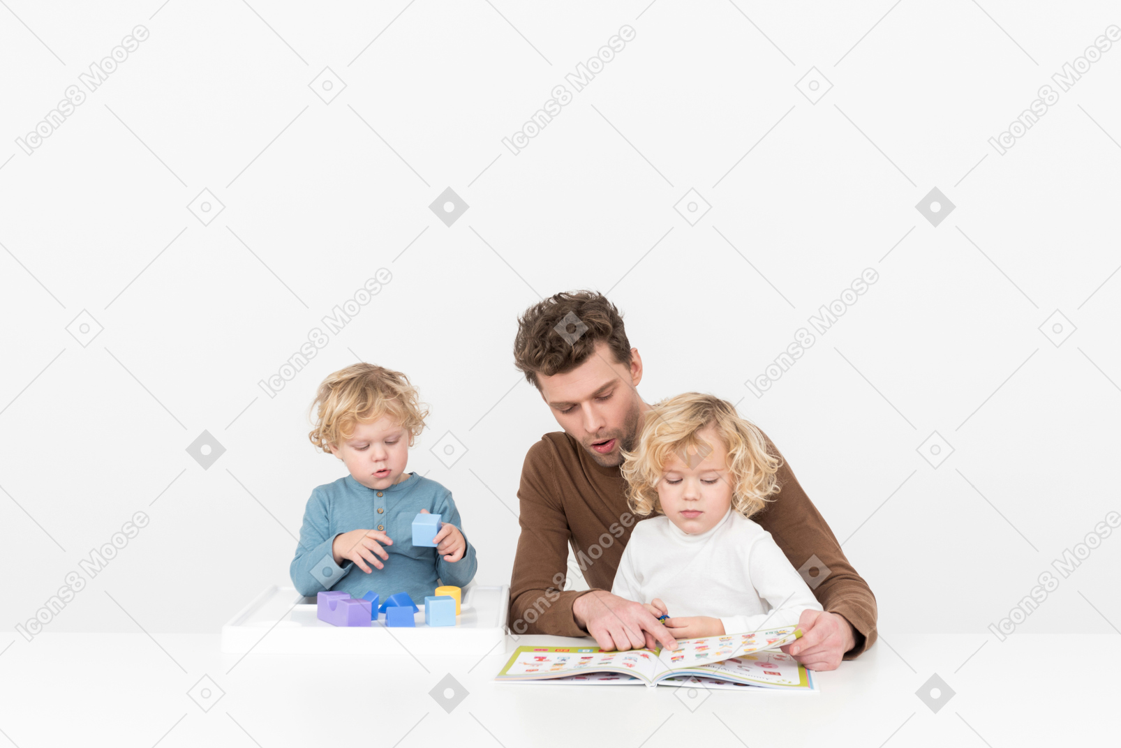 Father playing and reading with his sons