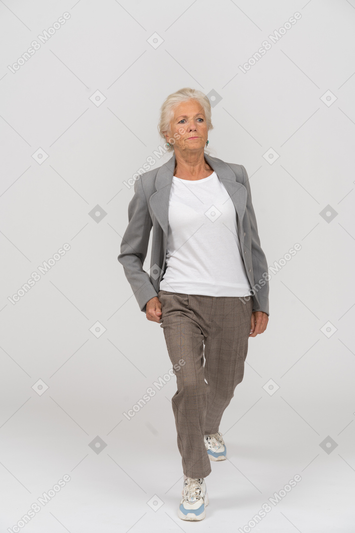 Front view of an old lady in suit exercising
