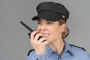 Female security guard speaking on the radio