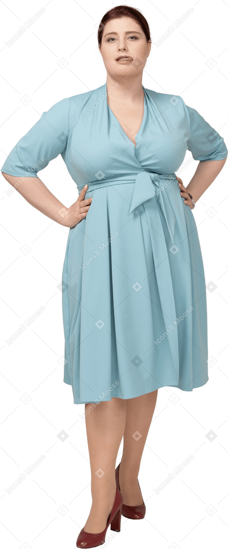 Front view of a woman in blue dress posing with hands on hips