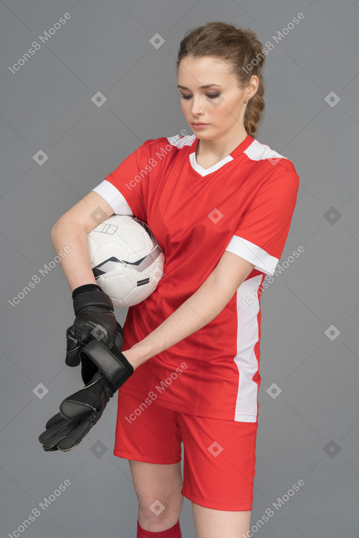 A sporty woman wearing goalkeeper gloves