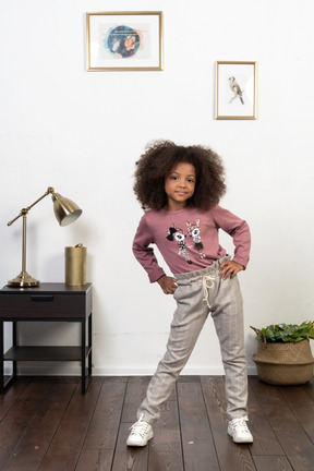 Cute girl kid posing on the apartments background