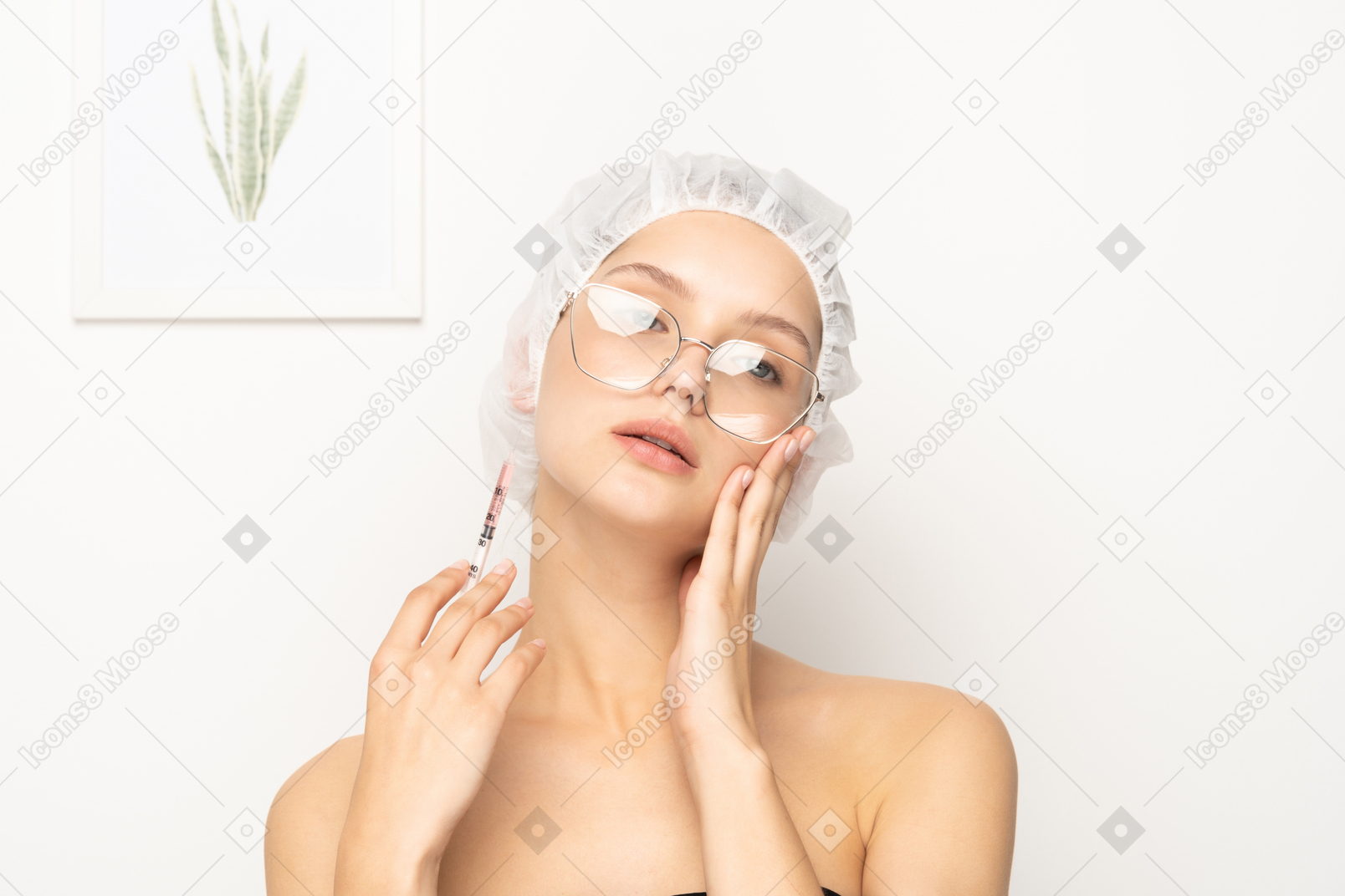 Young woman in glasses holding syringe