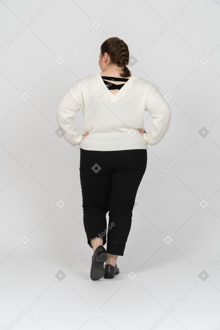 Plump woman in casual clothes posing
