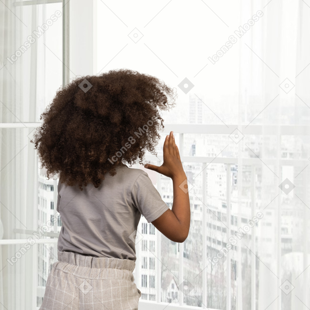 Girl standing in front of a window