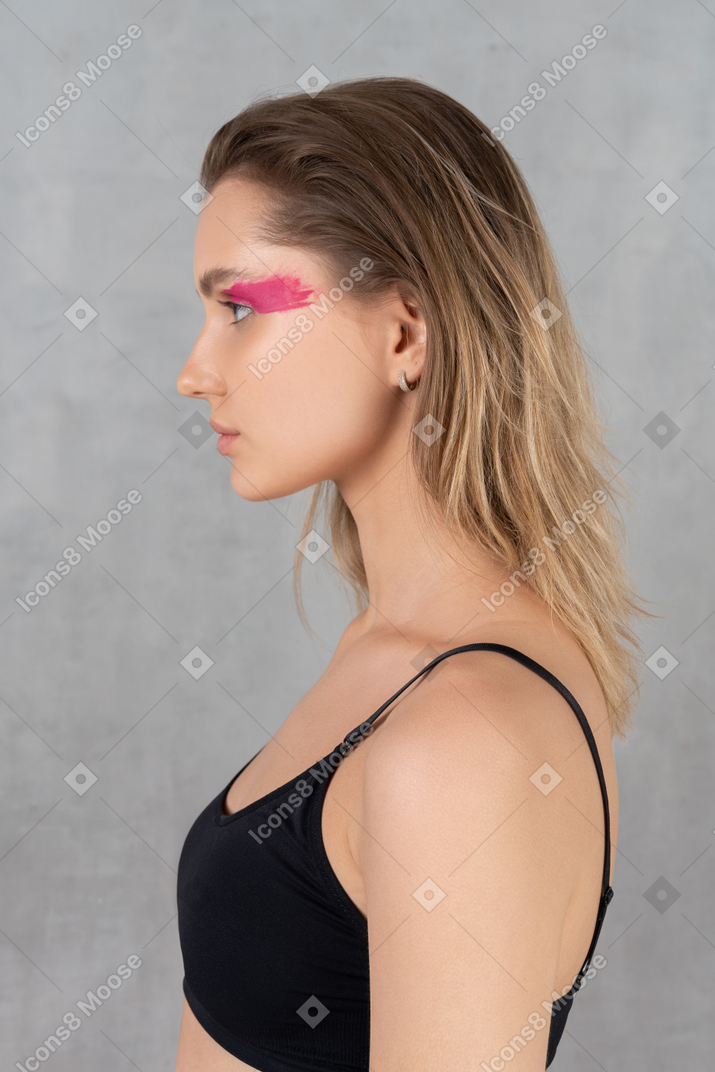 Side view of a beautiful woman with bright pink eye make-up