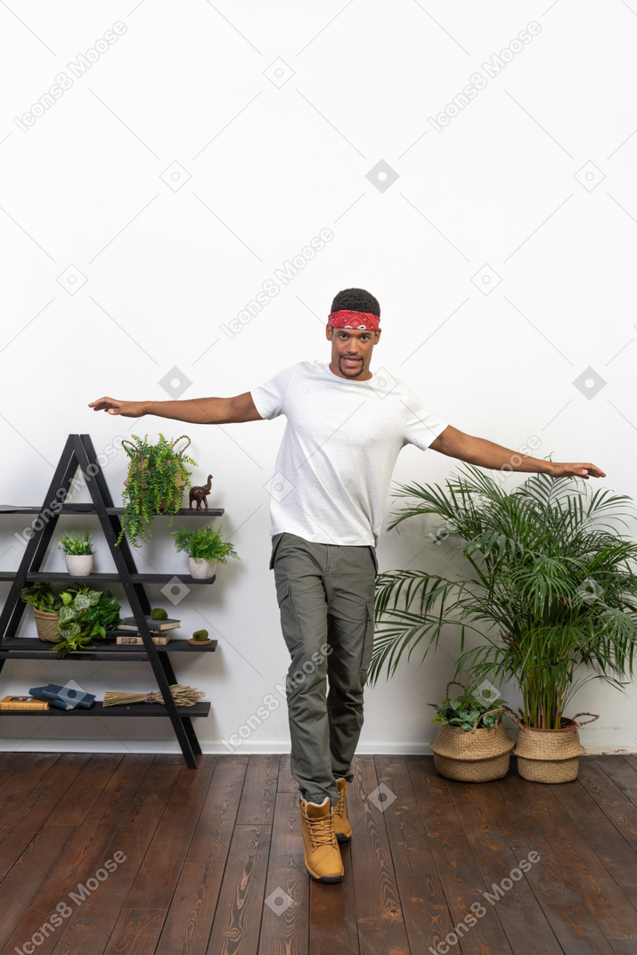 Good looking young man posing on the background of the apartment