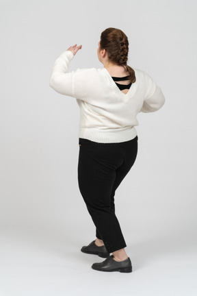 Rear view of plump woman in casual clothes