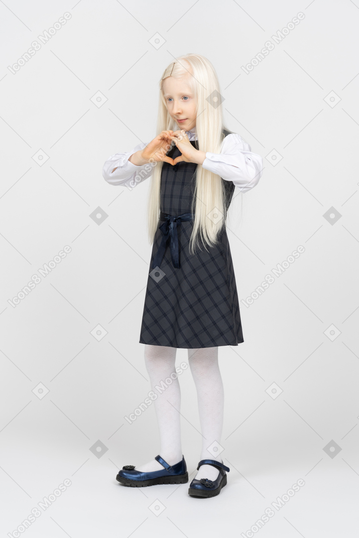 Schoolgirl making a heart with her hands