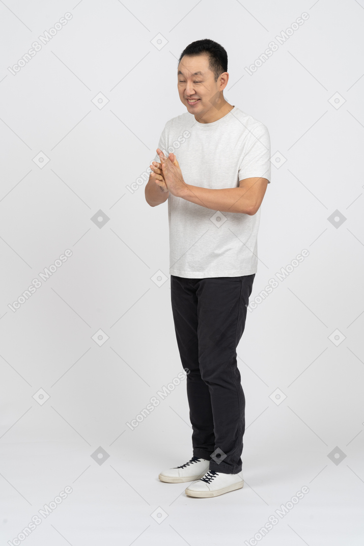 Front view of a happy man rubbing hands