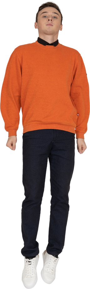 Young man in orange sweatshirt jumping