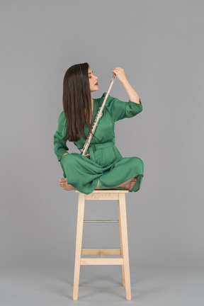 A female musician holding a flute