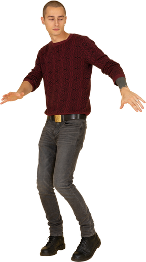 Three-quarter view of a dancing young man in red pullover