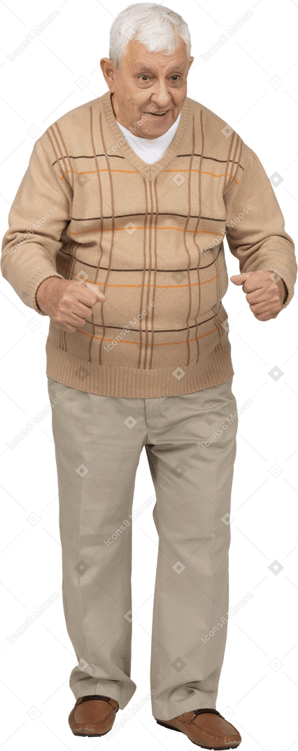 Front view of an old man in casual clothes standing with clenched fists
