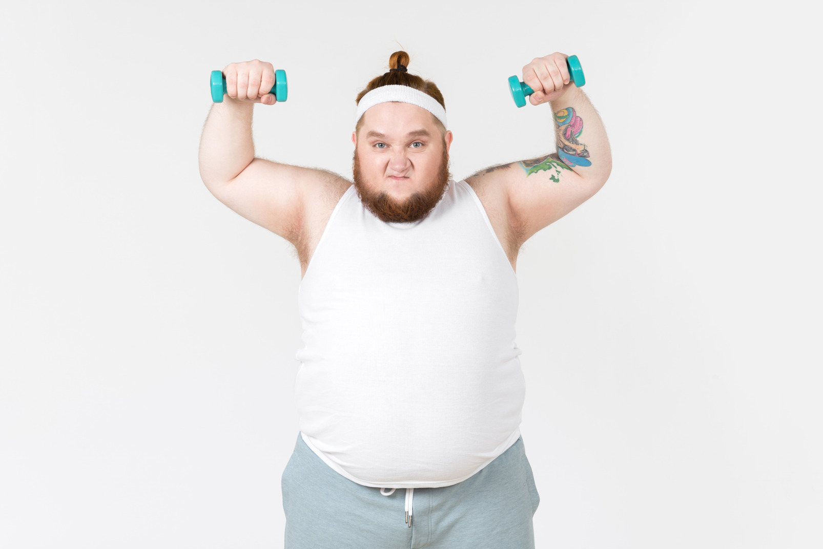 Big guy in sportswear lifting hand weights