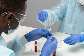 Specialists work with tubes in laboratory