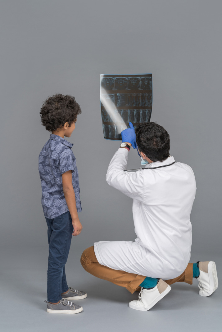 Boy looking at x-ray with doctor