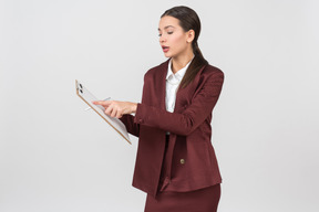 Attractive formally dressed woman checking notes