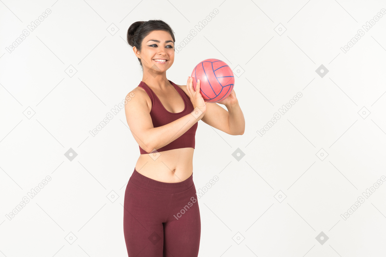Young indian woman in sportswear holding ball