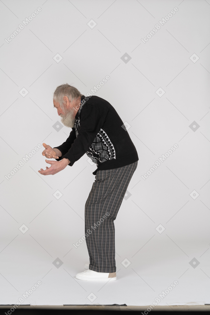 Side view of an old man crouching down