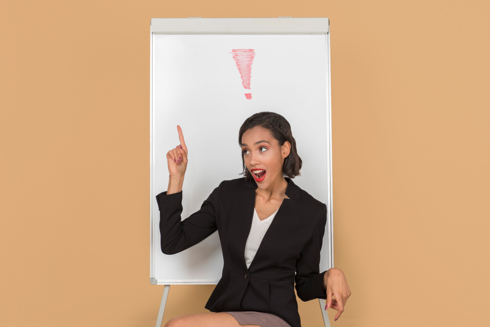 Attractive afro woman sitting by the whiteboard