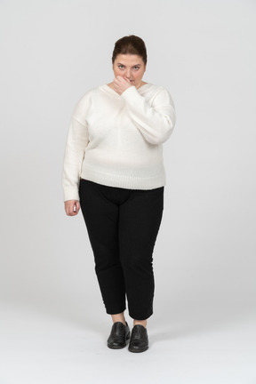Plump woman in white sweater looking at camera