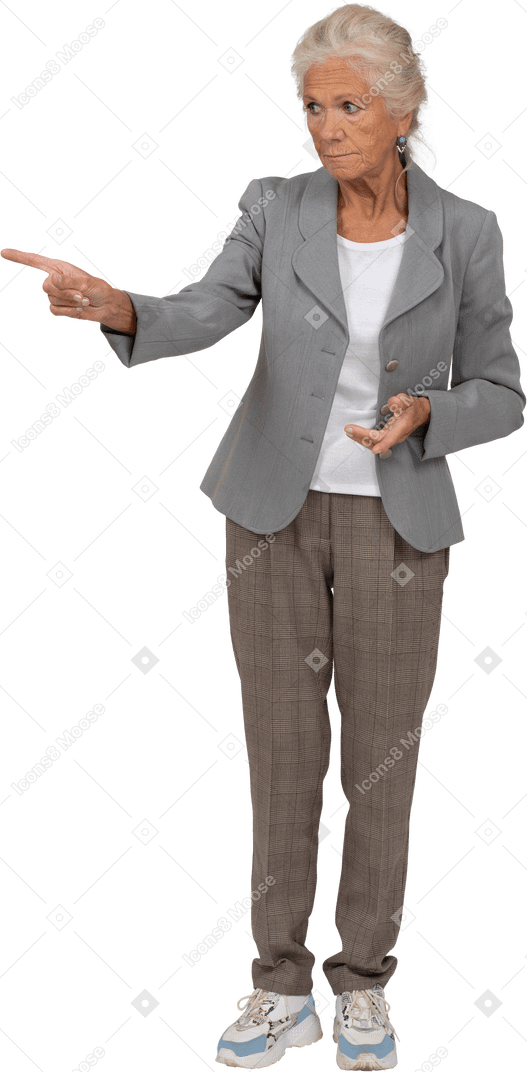 Front view of an old lady in suit pointing with finger