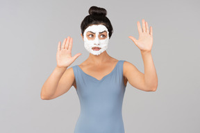 Woman with white mask on sending air kisses