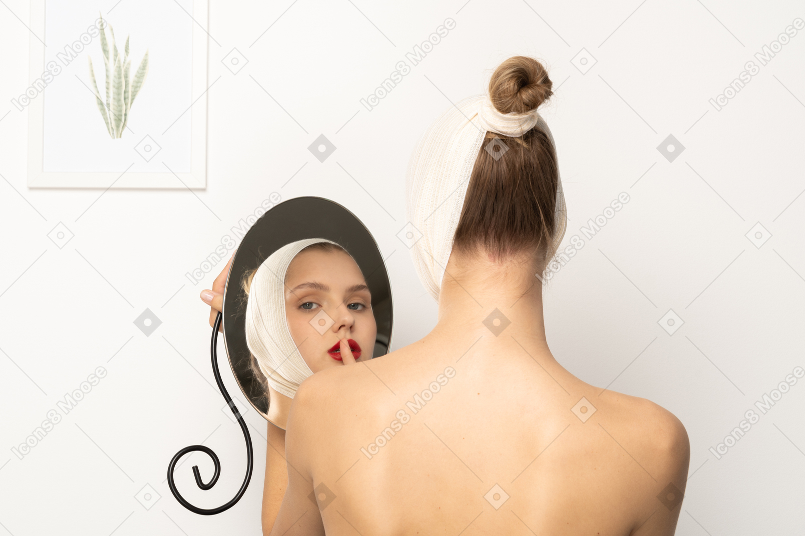 Young woman holding a mirror and making silence gesture