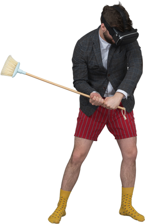 Man in vr headset with a broom